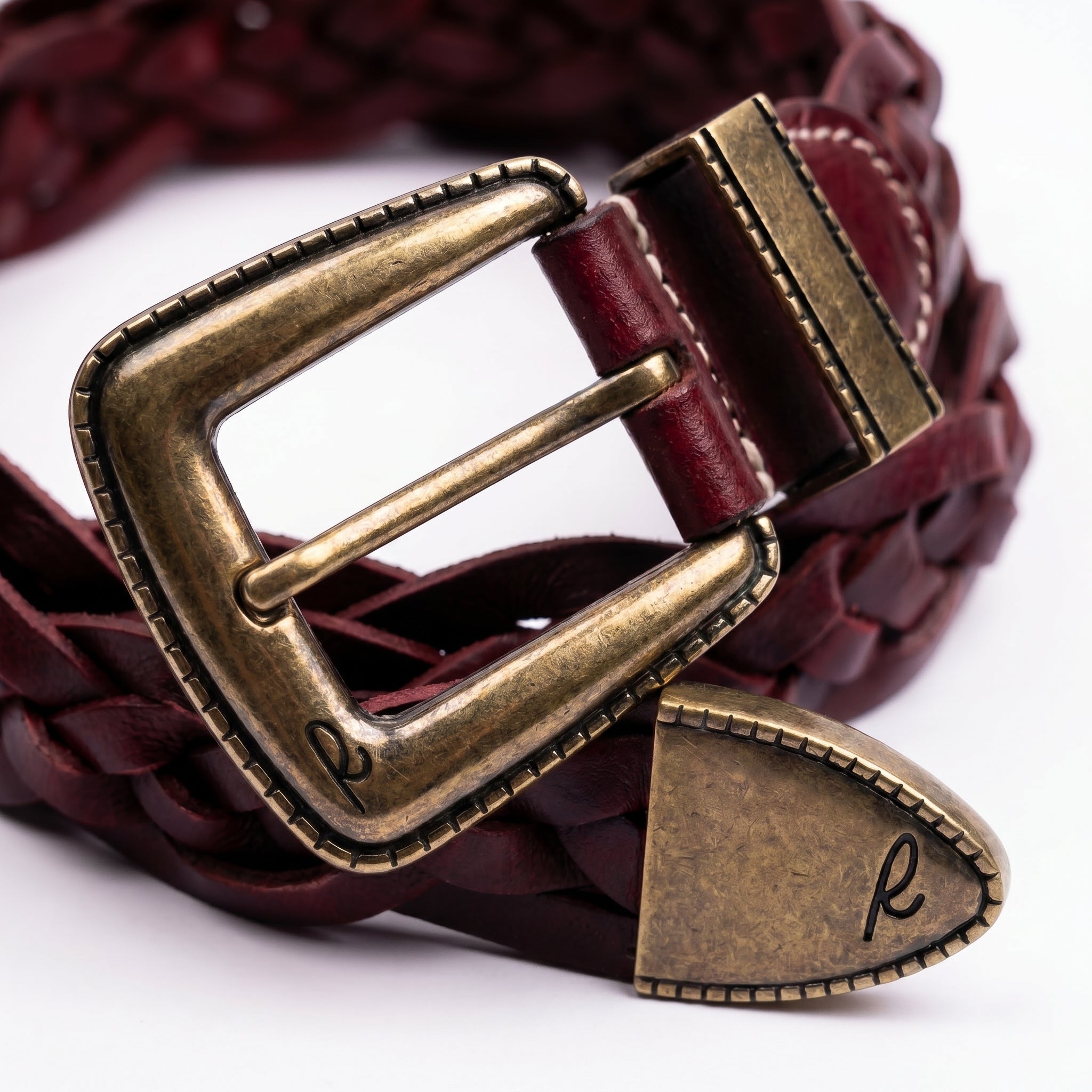 Rosso Windsor Brass close-up showing antique brass buckle finish and deep red braided leather texture